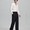 Side profile of model in white Oxford shirt and trousers, clean lines and sharp silhouette.