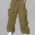 Man in brown baggy sweatpants, high waist, five pockets, back logo. White sneakers, standing front.