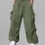 Man in light green baggy sweatpants, high waist, five pockets, back logo. White sneakers, standing front.