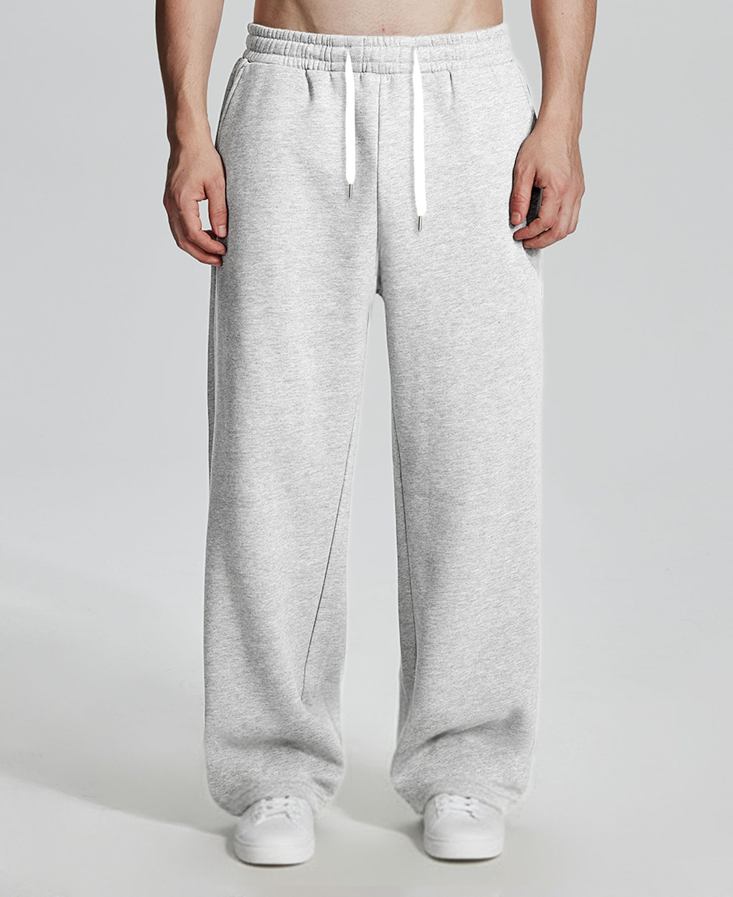 Model in white Men's Fleece Sweatpants ¨C Wide Leg Heavyweight Lounge Pants with white sneakers, showing drape and relaxed fit.