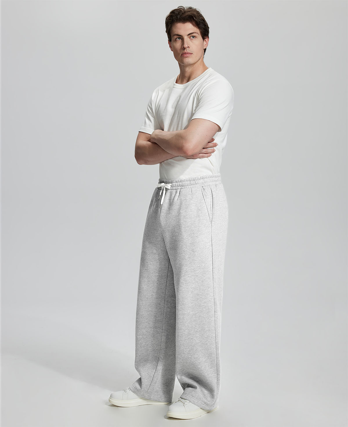 Side view of Men's Fleece Sweatpants ¨C wide-leg silhouette and cozy drape for ultimate comfort.