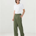 Model in white tee paired with army green Men's Pleated Baggy Dress Pants showing fresh casual style.