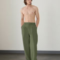 Wide leg silhouette of army green Men's Pleated Baggy Dress Pants comfortable fit with relaxed drape.