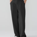 Model showcasing black Men's Pleated Baggy Dress Pants highlighting soft color and elegant drape.