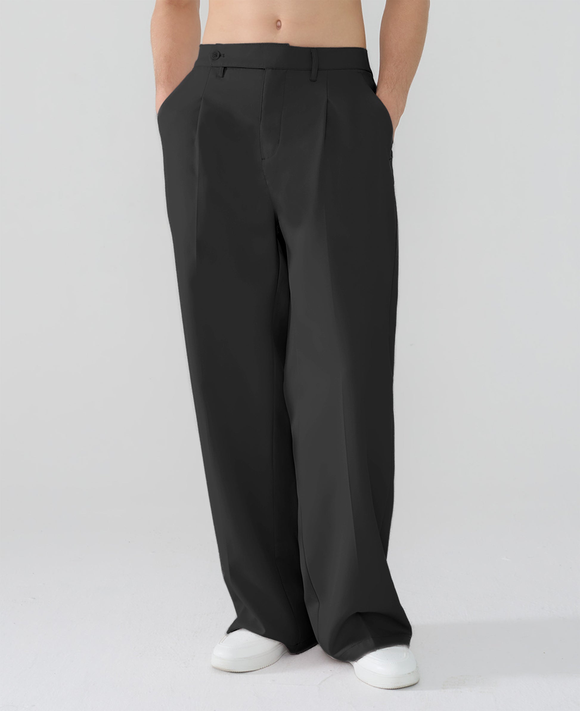 Model showcasing black Men's Pleated Baggy Dress Pants highlighting soft color and elegant drape.