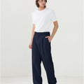 Model in white tee paired with black Men's Pleated Baggy Dress Pants showing fresh casual style.