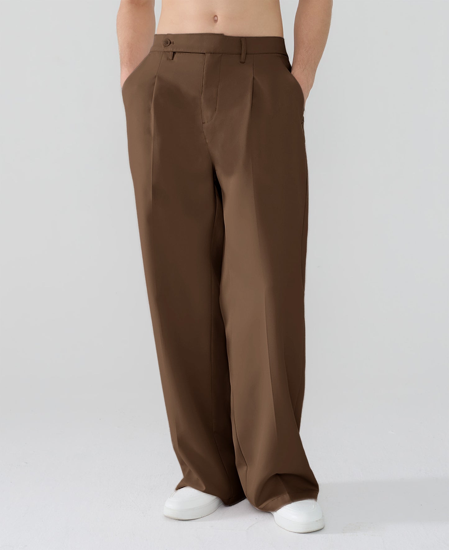Model showcasing brown Men's Pleated Baggy Dress Pants highlighting soft color and elegant drape.
