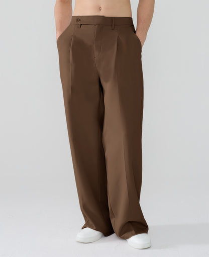 Model showcasing brown Men's Pleated Baggy Dress Pants highlighting soft color and elegant drape.