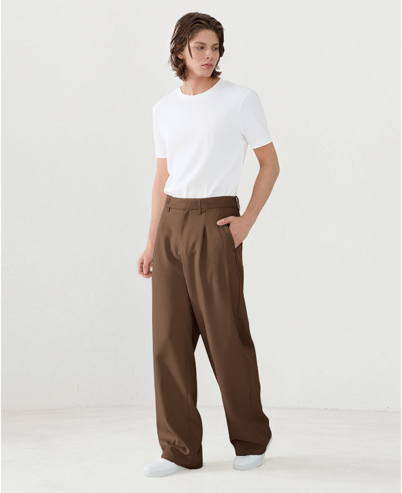 Model in white tee paired with brown Men's Pleated Baggy Dress Pants showing fresh casual style.