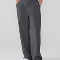 Model showcasing dark grey Men's Pleated Baggy Dress Pants highlighting soft color and elegant drape.