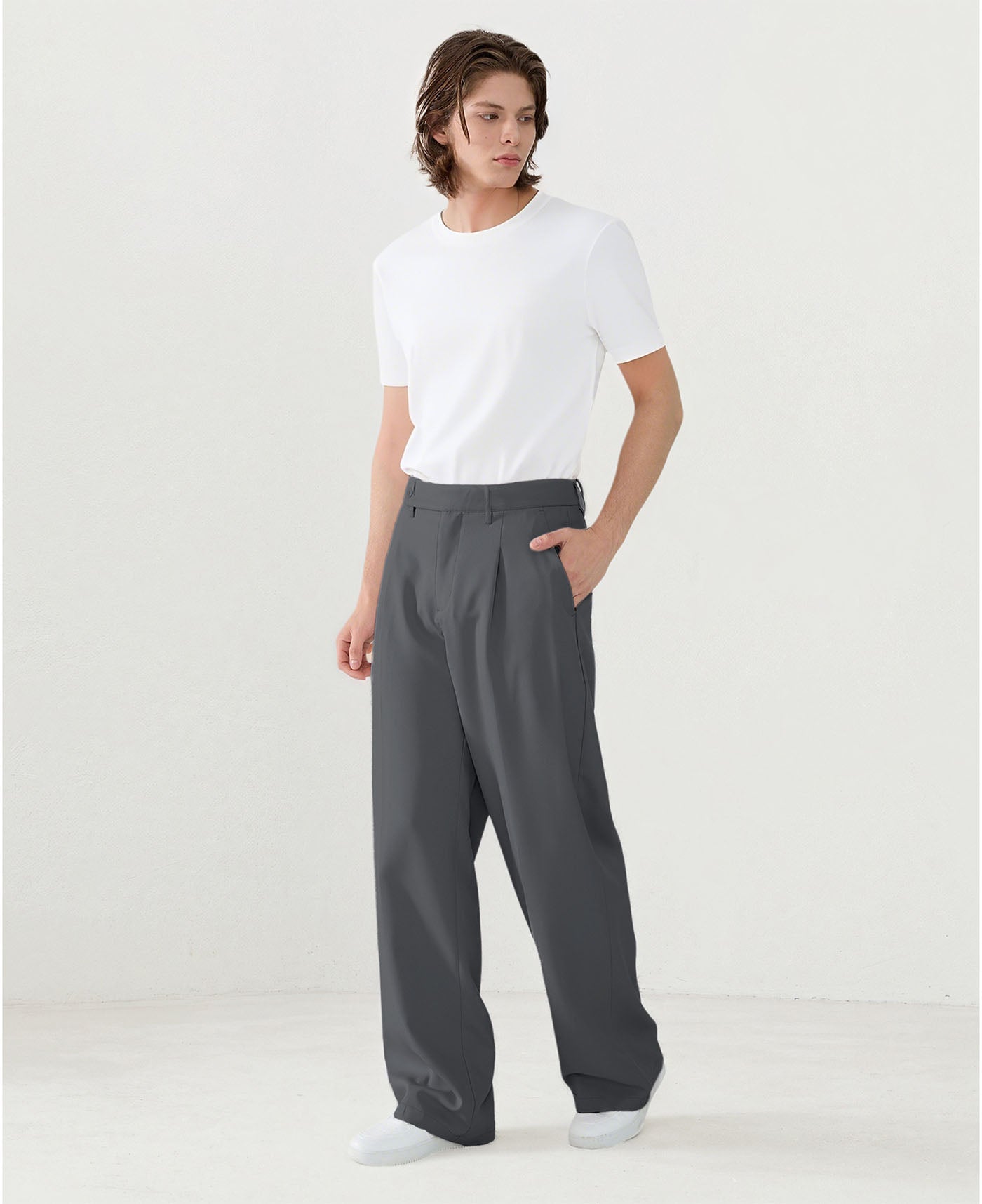 Model in white tee paired with dark grey Men's Pleated Baggy Dress Pants showing fresh casual style.