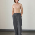 Wide leg silhouette of dark grey Men's Pleated Baggy Dress Pants comfortable fit with relaxed drape.