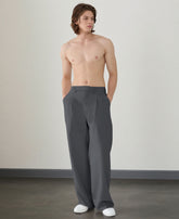 Wide leg silhouette of dark grey Men's Pleated Baggy Dress Pants comfortable fit with relaxed drape.
