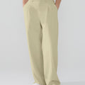 Model showcasing dark khaki Men's Pleated Baggy Dress Pants highlighting soft color and elegant drape.