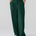 Model showcasing green Men's Pleated Baggy Dress Pants highlighting soft color and elegant drape.