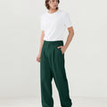 Model in white tee paired with green Men's Pleated Baggy Dress Pants showing fresh casual style.