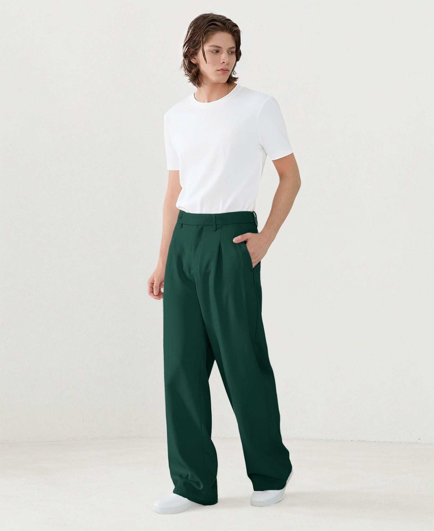 Model in white tee paired with green Men's Pleated Baggy Dress Pants showing fresh casual style.