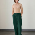 Wide leg silhouette of green Men's Pleated Baggy Dress Pants comfortable fit with relaxed drape.