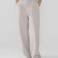 Model showcasing light gray Men's Pleated Baggy Dress Pants highlighting soft color and elegant drape.