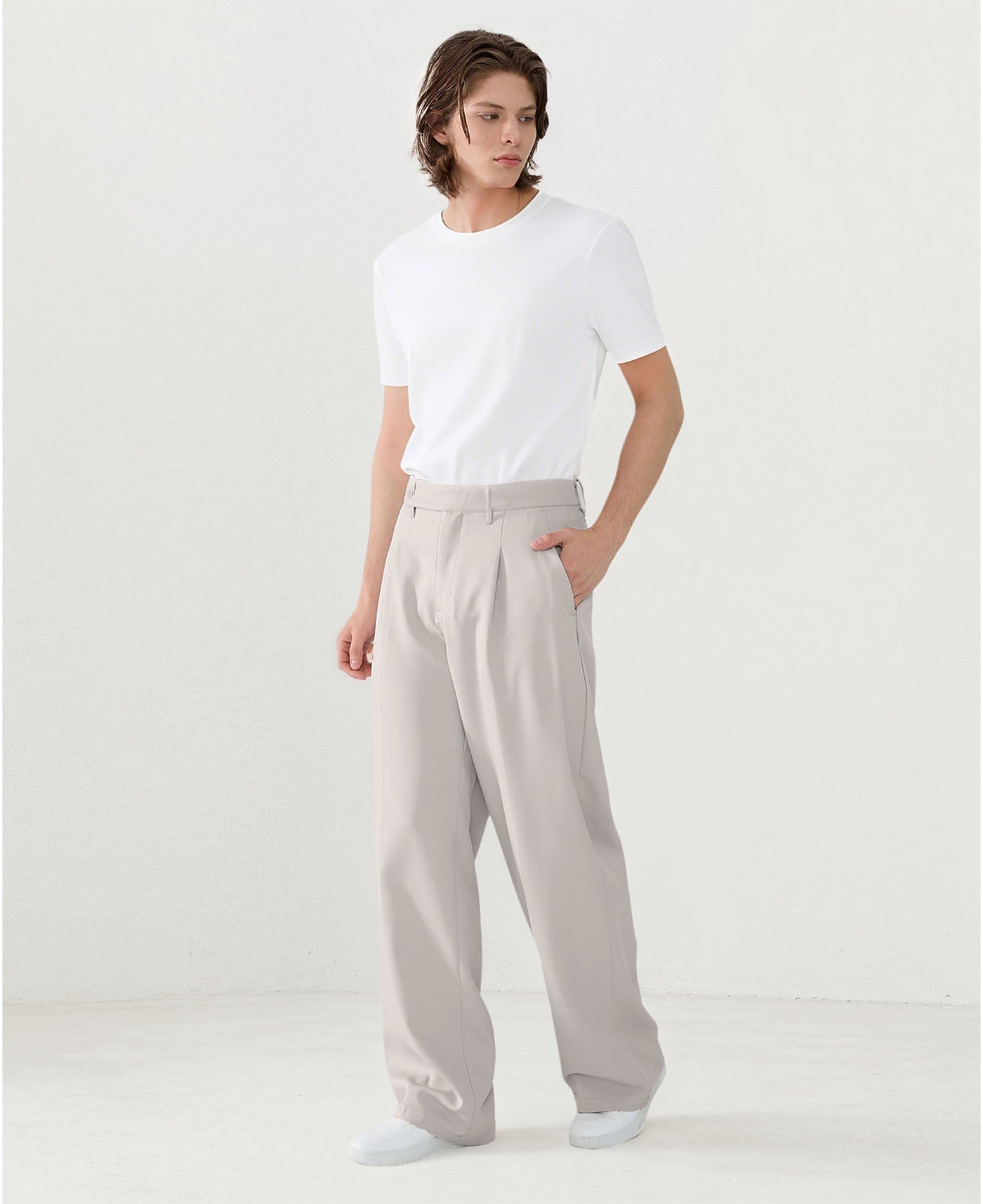 Model in white tee paired with light gray Men's Pleated Baggy Dress Pants showing fresh casual style.