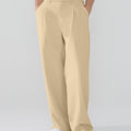 Model showcasing light khaki Men's Pleated Baggy Dress Pants highlighting soft color and elegant drape.
