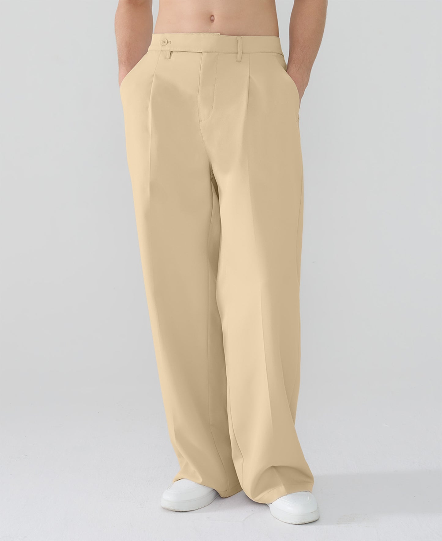 Model showcasing light khaki Men's Pleated Baggy Dress Pants highlighting soft color and elegant drape.