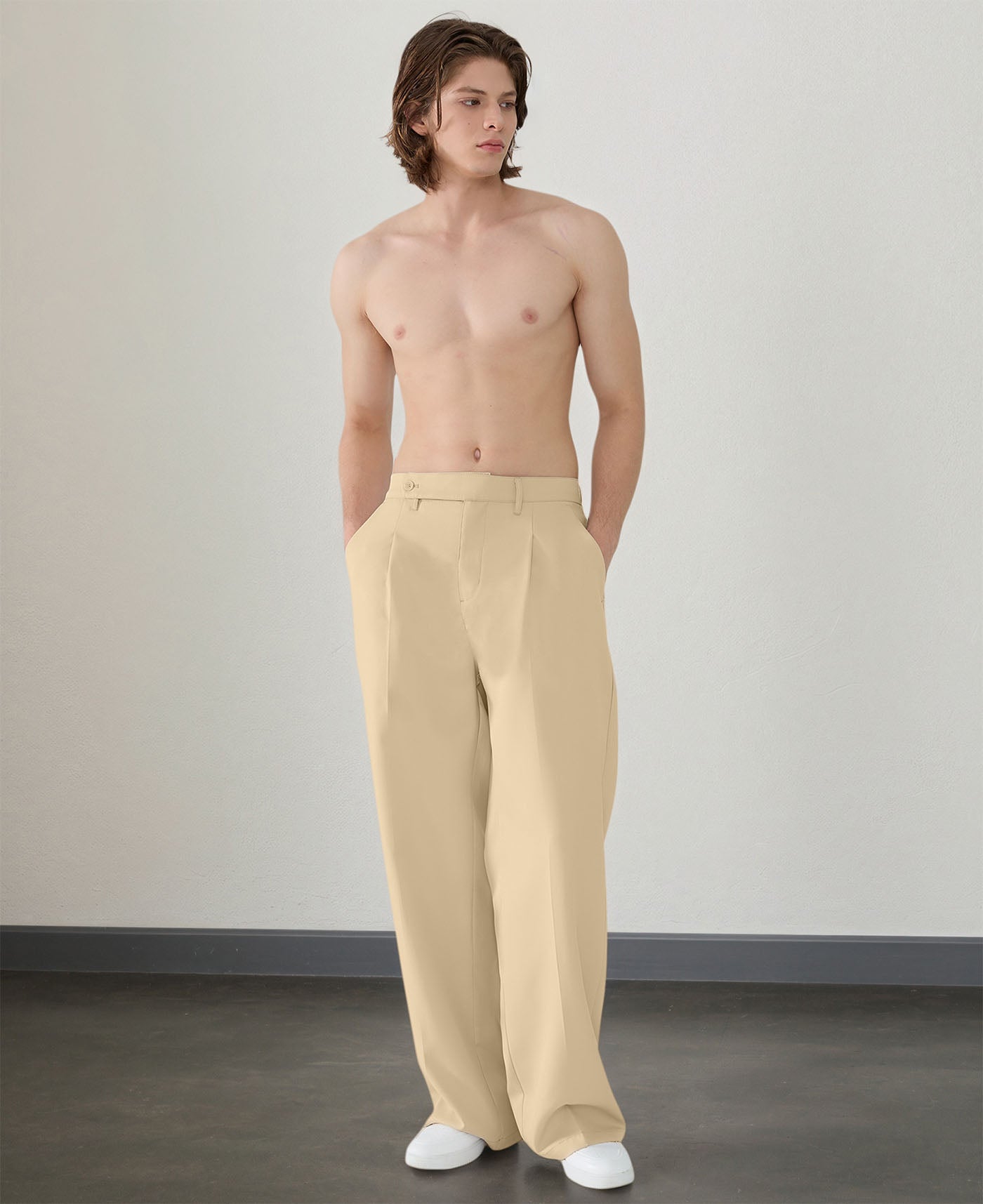 Wide leg silhouette of light khaki Men's Pleated Baggy Dress Pants comfortable fit with relaxed drape.