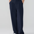 Model showcasing navy blue Men's Pleated Baggy Dress Pants highlighting soft color and elegant drape.