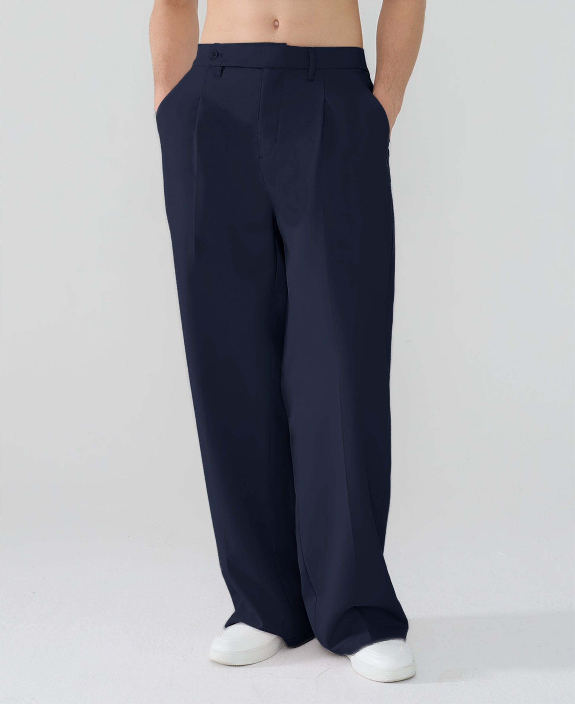 Model showcasing navy blue Men's Pleated Baggy Dress Pants highlighting soft color and elegant drape.