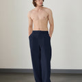 Wide leg silhouette of navy blue Men's Pleated Baggy Dress Pants comfortable fit with relaxed drape.