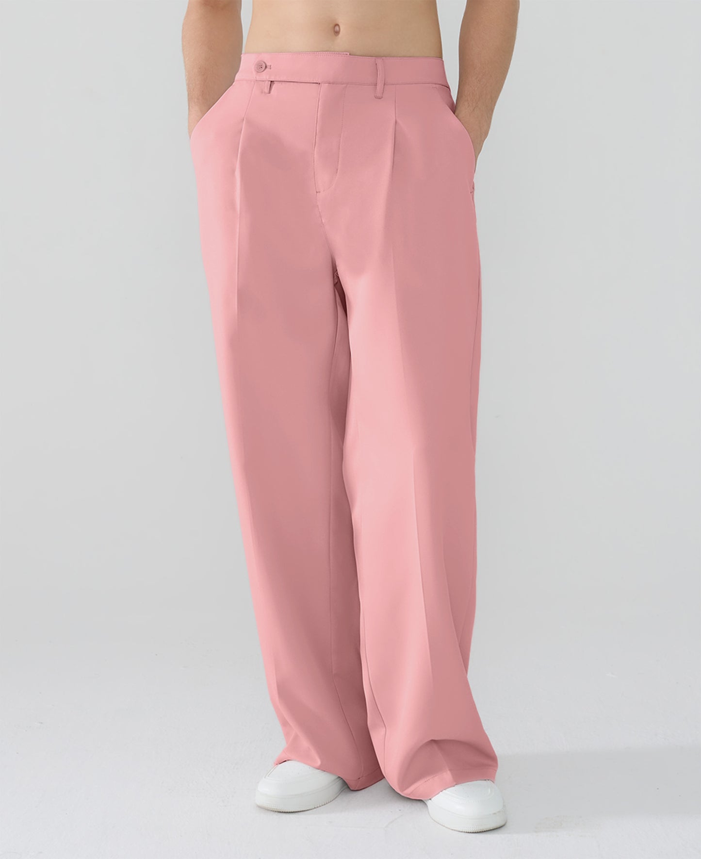 Model showcasing pink Men's Pleated Baggy Dress Pants highlighting soft color and elegant drape.