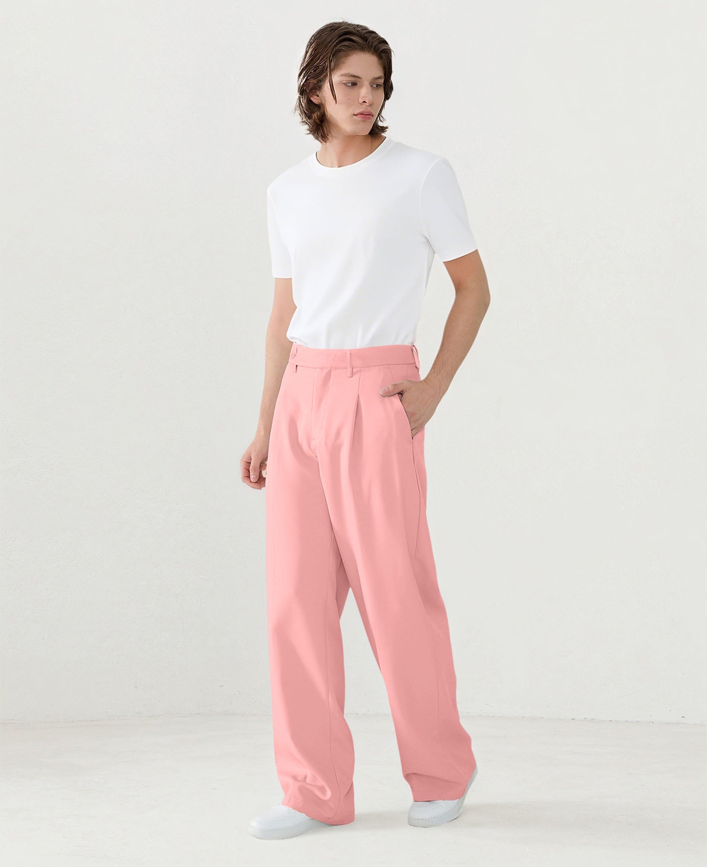 Model in white tee paired with pink Men's Pleated Baggy Dress Pants showing fresh casual style.