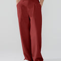 Model showcasing red Men's Pleated Baggy Dress Pants highlighting soft color and elegant drape.