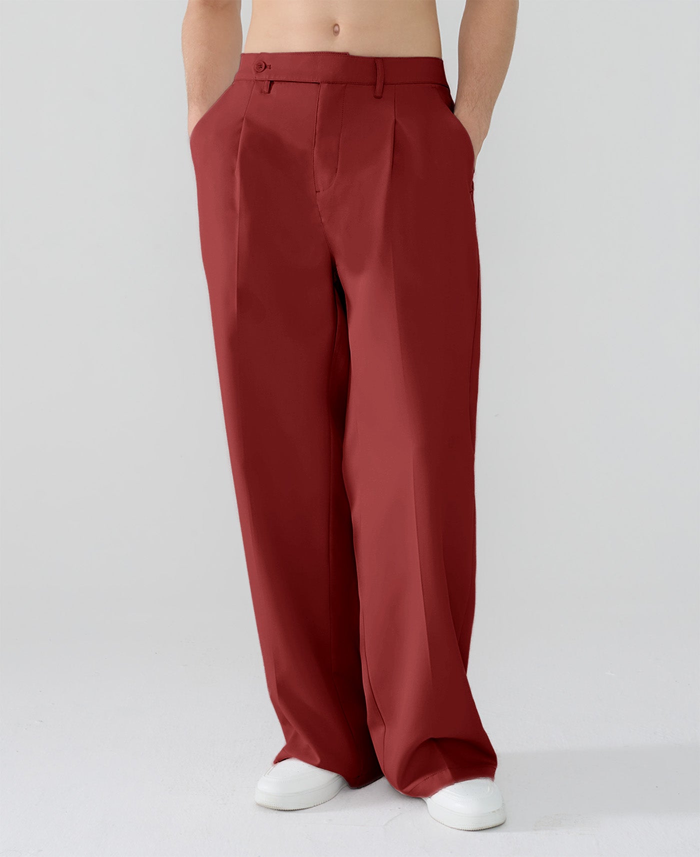 Model showcasing red Men's Pleated Baggy Dress Pants highlighting soft color and elegant drape.