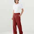 Model in white tee paired with red Men's Pleated Baggy Dress Pants showing fresh casual style.