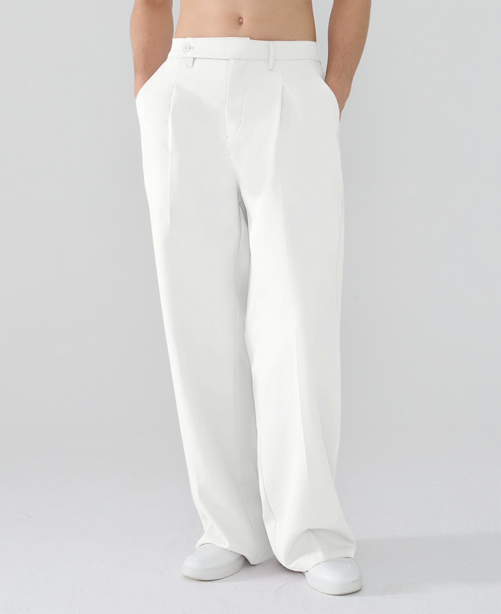 Model showcasing white Men's Pleated Baggy Dress Pants highlighting soft color and elegant drape.