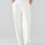 Model showcasing white Men's Pleated Baggy Dress Pants highlighting soft color and elegant drape.