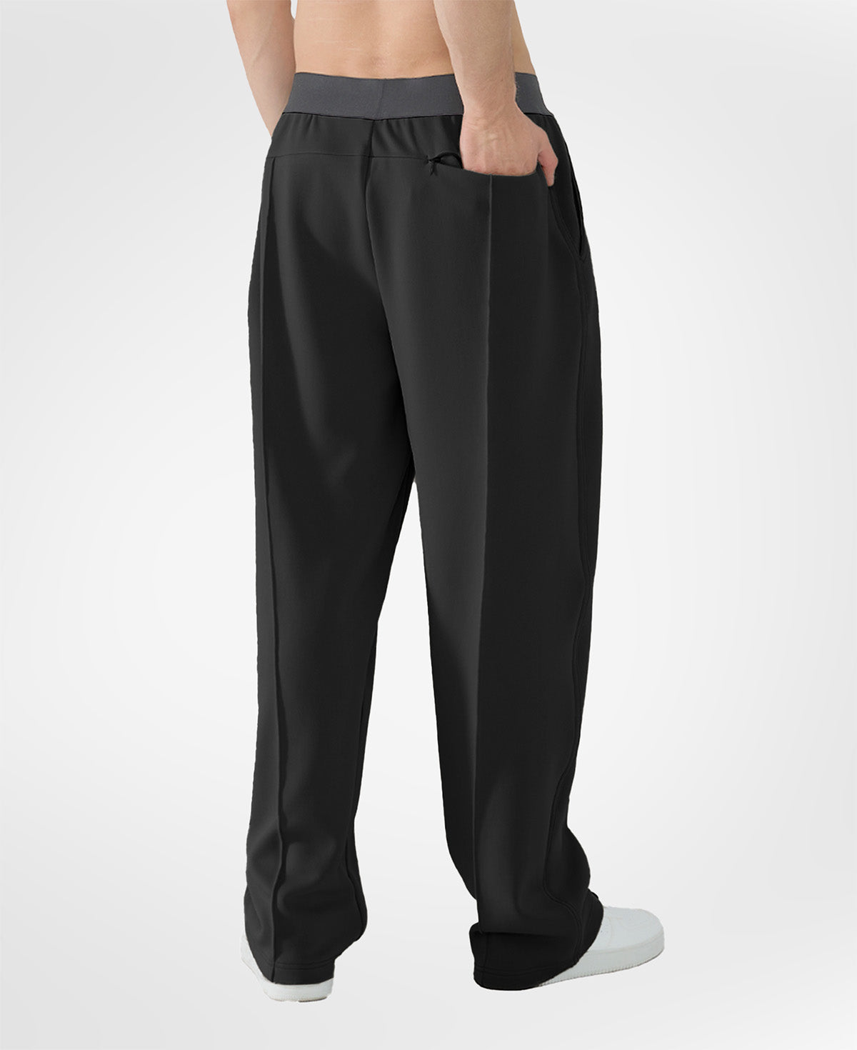 Back view of black pants showing rear pocket and overall silhouette, man with hand in back pocket for storage detail.