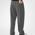 Back view of dark grey pants showing rear pocket and overall silhouette, man with hand in back pocket for storage detail.