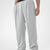 Man in light grey pleated baggy sweatpants with white shoes, hand in pocket, showcasing wide leg and contrasting elastic waist.