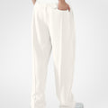 Back view of white pants showing rear pocket and overall silhouette, man with hand in back pocket for storage detail.
