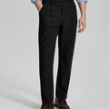 Man in light blue shirt, black Mens Pleated Dress Pants, and brown shoes showcasing regular fit & straight-leg style.