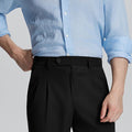 Close-up of waistband on Mens Pleated Dress Pants, highlighting button closure and tailored pleats for a refined look.