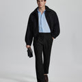 Model in black blazer, light blue shirt, and Mens Pleated Dress Pants showing smart business casual outfit with regular fit trousers.