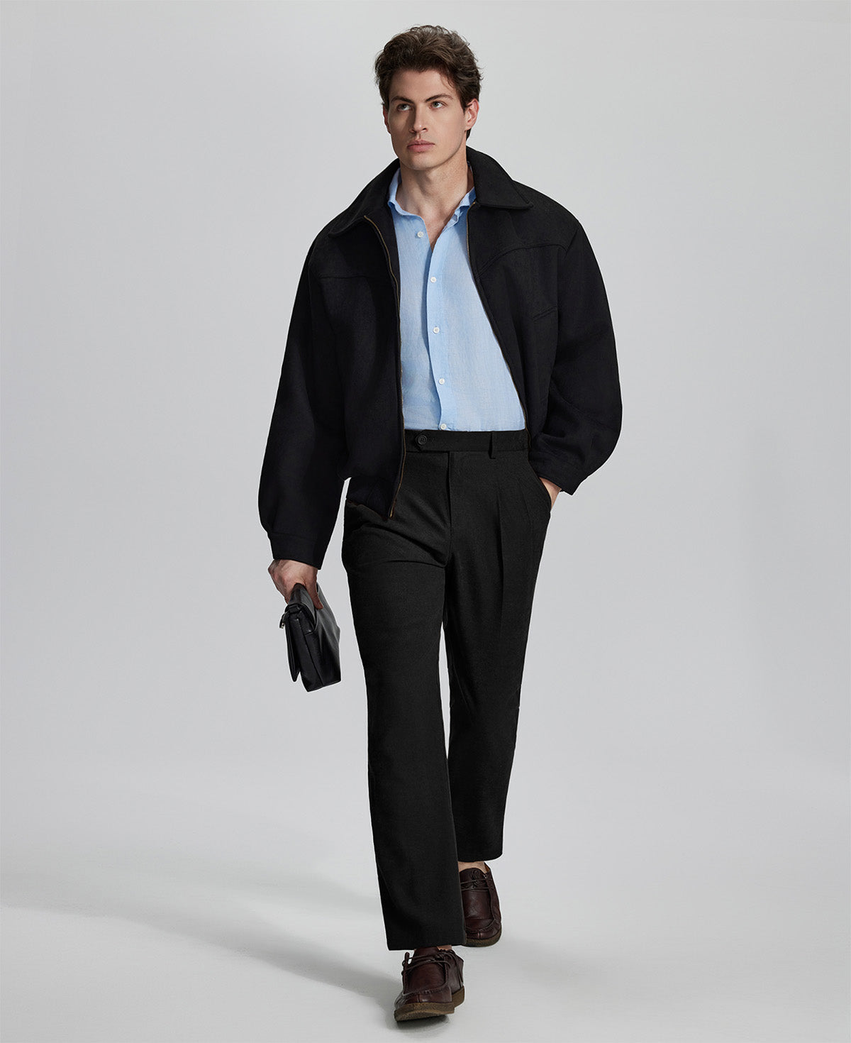 Model in black blazer, light blue shirt, and Mens Pleated Dress Pants showing smart business casual outfit with regular fit trousers.