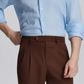Close-up of waistband on Mens Pleated Dress Pants, highlighting button closure and tailored pleats for a refined look.