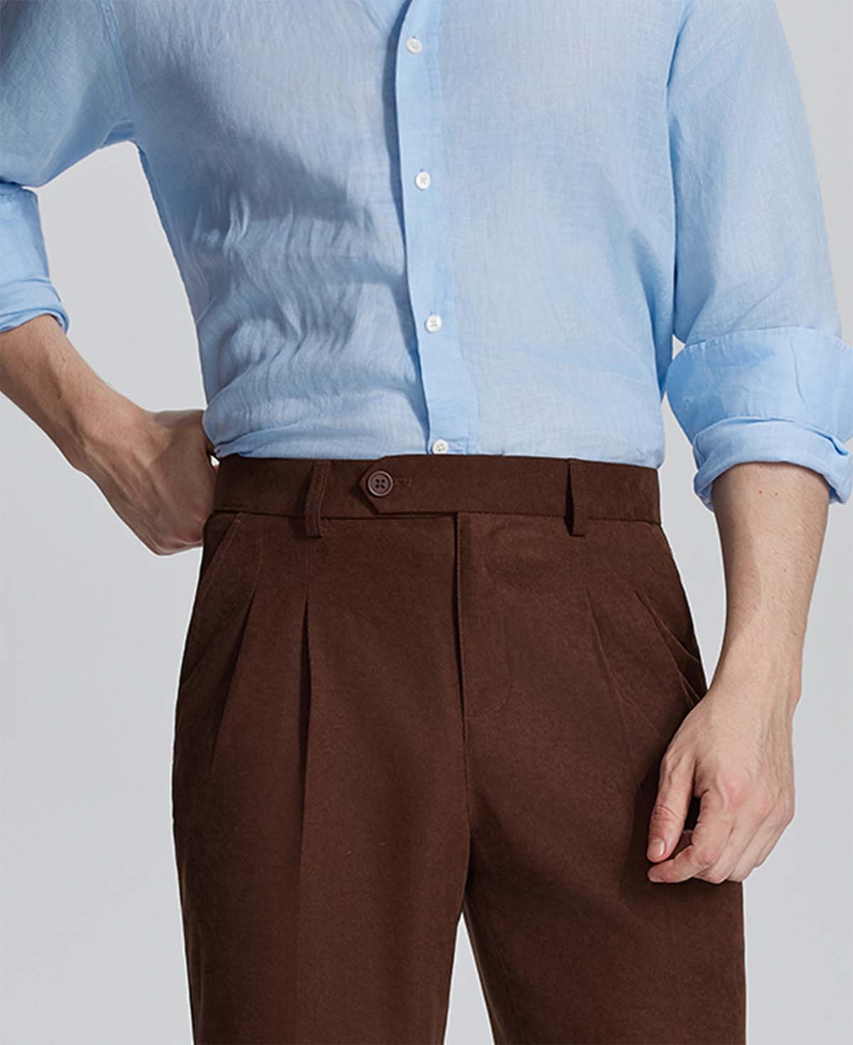 Close-up of waistband on Mens Pleated Dress Pants, highlighting button closure and tailored pleats for a refined look.