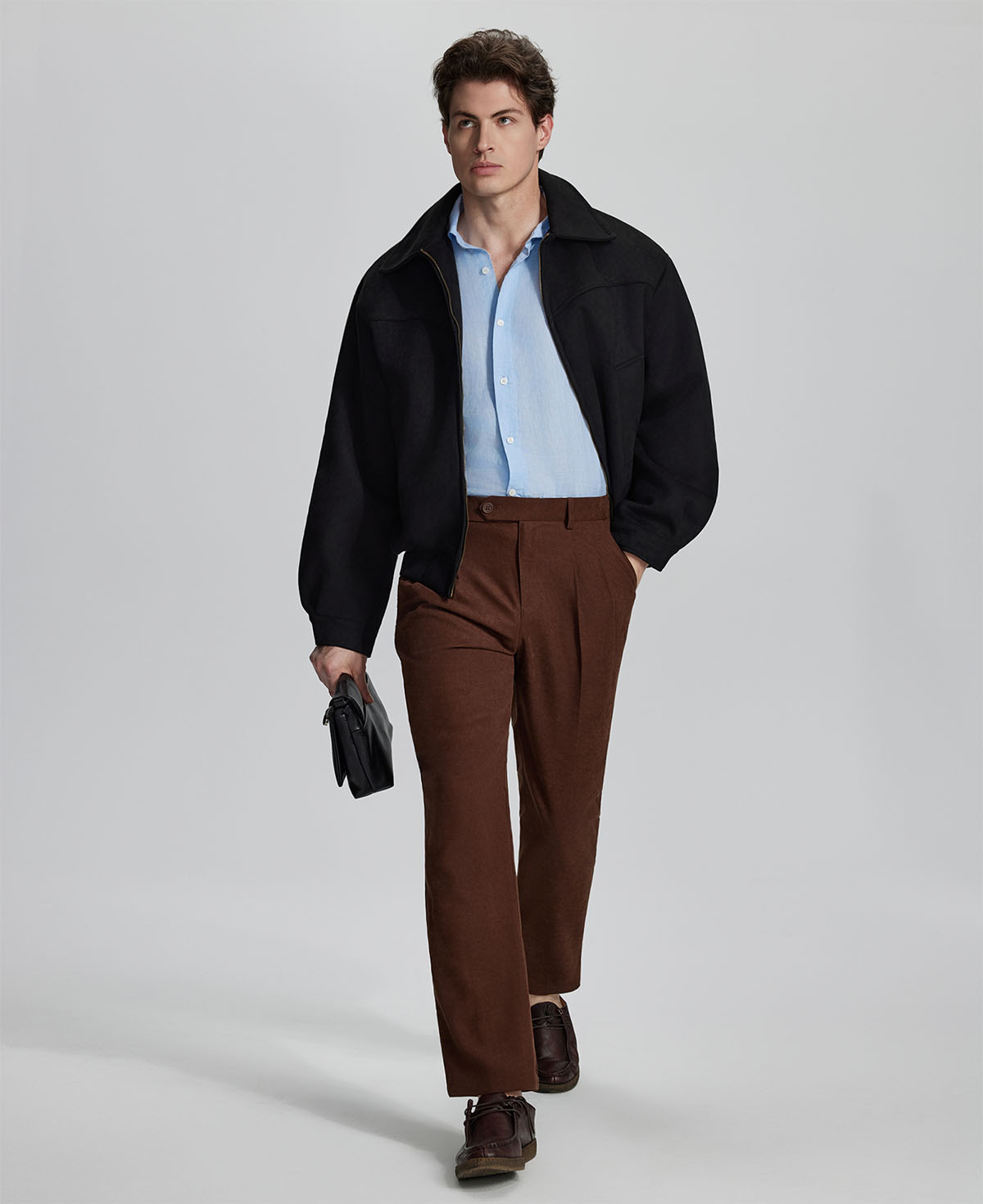Model in coffee blazer, light blue shirt, and Mens Pleated Dress Pants showing smart business casual outfit with regular fit trousers.