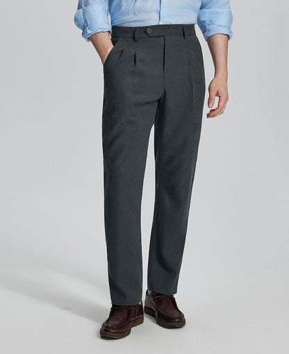 Man in light blue shirt, grey Mens Pleated Dress Pants, and brown shoes showcasing regular fit & straight-leg style.