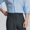 Close-up of waistband on Mens Pleated Dress Pants, highlighting button closure and tailored pleats for a refined look.